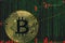 Token btc bitcoin cryptocurrency on the background of binary crypto matrix text and price chart.