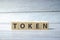 TOKEN word written on wood block. NFT concept