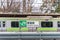 TOKYO, JAPAN - JANUARY 25TH, 2019.Harajuku Train station sign and Yamanote line train in background.This train station operated by