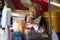 Tokyo, Japan May 3 ,2019 an old woman holding a plastic glass sitting in a street food shop
