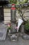Tokyo,Japan - Peaceful stone religious Jizo statue with red hat