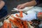 Tokyo, Japan Street in Tsukiji outer market in Ginza with closeup retail sample display of cooked red crab lobster legs white meat