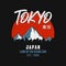 Tokyo, Japan typography graphics for slogan t-shirt with mountains and silhouette of city landscape.