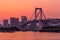 Tokyo skyline and rainbow bridge at sunset in Odaiba waterfront.