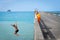 Tolaga Bay New Zealand - February 5 2022; Local boys jumping of Tolaga Bay Wharf under encouragement of their father