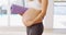 They told me yoga was good for the baby. Cropped shot of an unrecognizable young pregnant woman carrying a yoga mat.