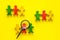 Tolerance concept. Social research. eople cutouts under magnifier on yellow background top-down copy space