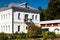 Tolga monastery garden and white historical building in sunny summer day