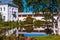 Tolga monastery pond and white buildings in sunny summer day