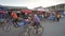 Toliara, Madagascar - May 01, 2019: Typical evening scene at busy crossroad, people walking, bicycle rickshaw passing by,