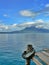 Toliman volcano on horizon of Lake Atitlan, bright blue sky Guatemala