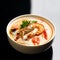 Tom yam kong or Tom yum spicy Thailand Dish Cuisine soup with king prawn chili pepper and mashrooms