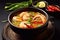 Tom Yam kung Spicy Thai soup with shrimp in a black bowl