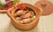 Tom Yum Goong in a clay pot spicy soup traditional thai food cuisine in Thailand on mat wicker background,Tom Yum Kung,Thai Food