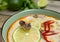 Tom yum soup close-up: baby octopus on a slice of lime, chili peppers in tom yum soup