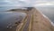 Toma aerea lateral de extensa ruta sobre costas de playa,en Laguna Garzon,Maldonado,Uruguay