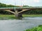 Tomas Masaryk Bridge in Uzhhorod close-up and people wade the river ford under it