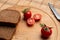 Tomates with black bread for lunch, Black bread with tomato on the wooden background