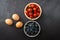 Tomato , blue berry and egg on bowl in  chalkboard background