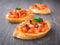 Tomato bruschetta topped with olive