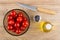 Tomato cherries in bowl, knife, salt, vegetable oil