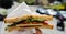 Tomato, coconut based alternative to cheese, pickle, lettuce and vegan dressing on malted bread