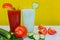 Tomato and cucumber cocktail, tomatoes and cucumbers, diet drinks on a yellow background