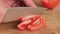 Tomato cutting closeup. Chef slices the cherry tomato.