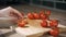 Tomato cutting closeup. Chef slices the cherry tomato. Knife, cutting Board, cherry tomato.