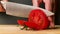 Tomato cutting closeup. Chef slices the cherry tomato. Knife, cutting Board, cherry tomato. Ring of cherry tomato.The hands of the