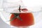 Tomato floats in water with bubbles in glass glass glass on white background