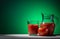 Tomato, glass and jug of tomato juice on green background