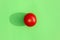 Tomato with a hard shadow on a colored background pattern