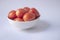 Tomato isolate. Tomatoes in a white bowl on white background.