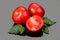 Tomato. Ripe natural tomatoes close-up. Organic tomato with leaves on gray background