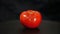 Tomato rotation on black background.