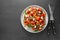 Tomato salad with arugula. Fresh summer foods. Healthy food, vegetarian low calories salad