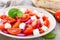 Tomato salad with fresh red onion and feta cheese. Healthy eating