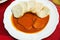 Tomato sauce, beef and dumpling on white plate