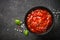 Tomato sauce in a bowl at black stone table.