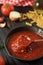 Tomato Sauce with Wooden Spoon in Cast Iron Skillet Pan