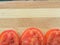 Tomato slice line on wooden background