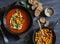 Tomato soup with spicy fried chickpeas on a dark wooden table, top view. Healthy vegetarian food