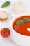 Tomato soup with tomatoes and baguette in bowl