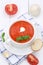 Tomato soup with tomatoes and baguette in cup