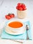 Tomato soup with tomatoes on the white table