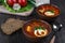 Tomato soup . Traditional Ukrainian beetroot and tomato soup - borsch in clay pot with sour cream, garlic, herbs and bread