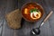 Tomato soup . Traditional Ukrainian beetroot and tomato soup - borsch in clay pot with sour cream, herbs and bread