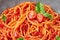 Tomato spaghetti in gray bowl. Tomato sauce pasta is classic italian cuisine dish. Popular italian food. Close up