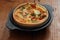 Tomato and spring onion quiche in a cast iron pot dish